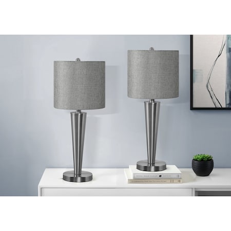Two matching table lamps with gray fabric drum shades and brushed silver tapered bases, displayed on a white console table against a light gray wall.